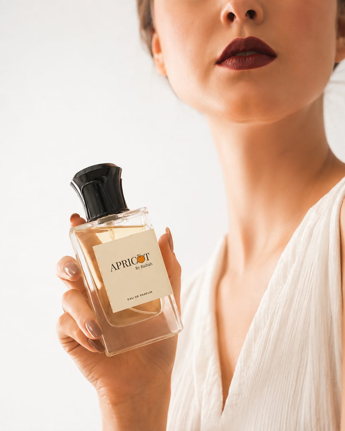 Apricot by Raihah eau de parfum held by a woman
